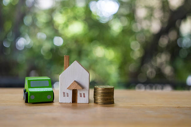 istock A toy house and car next to a stack of coin 2219653866