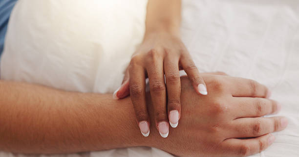 istock Hands, touch and couple sleeping at house for intimacy, partner affection and connection in morning. Closeup, people and nap on bed with embrace for care, romance and bonding for marriage commitment 2219654041