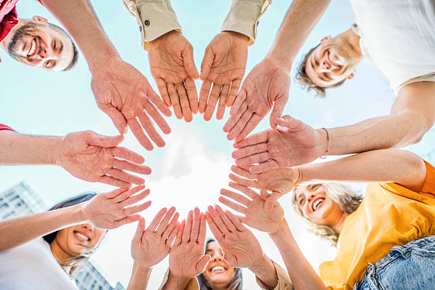 istock Diverse young people stacking hands together - Youth community concept 2219654300