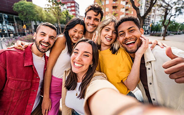 istock Multicultural cheerful friends taking selfie pic with smart mobile phone device - Youth community people laughing at camera together - Friendship concept with guys and girls having fun outdoors 2219654437