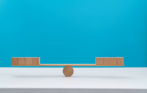 istock Blank cubes on wooden seesaw 2219657017