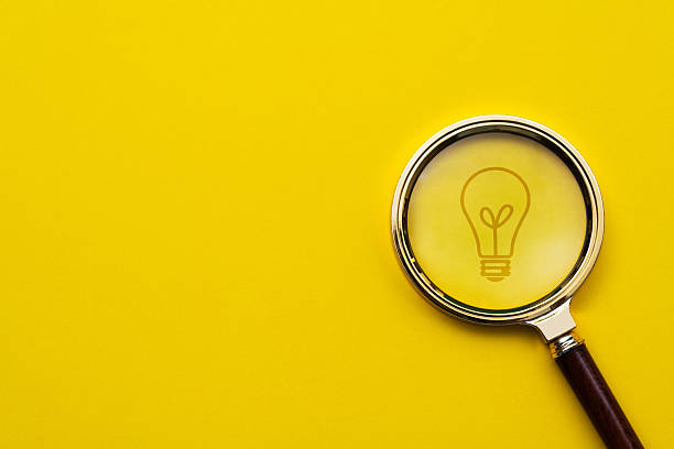 istock Magnifying glass in front of light bulb 2219657085