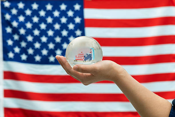 World globe in front of American flag.