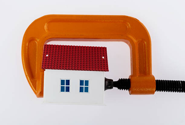 Orange clamp with a model house.