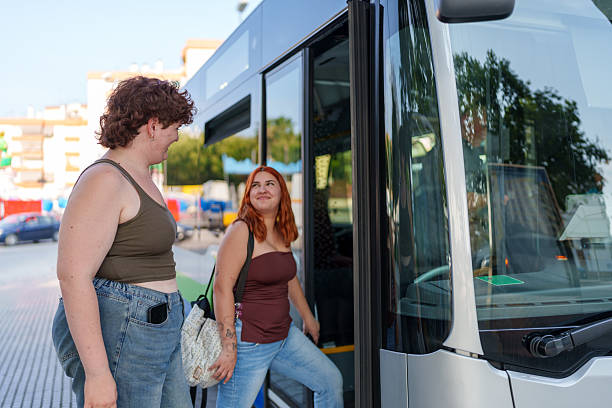 istock Young women boarding the bus during a summer day 2219658396