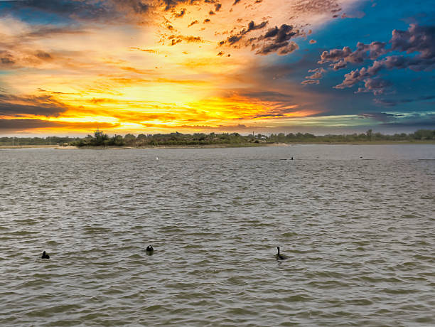 Picture of beautiful sunset over the lake with cloudy sky. Nature composition.