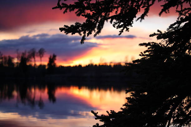 Vibrant yellow orange red colors in the sky reflections on the water.