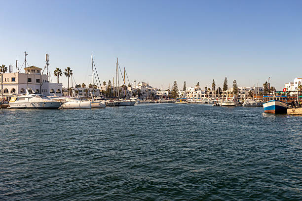 istock A sunny day at a harbor with boats docked and calm waters. 2219660555