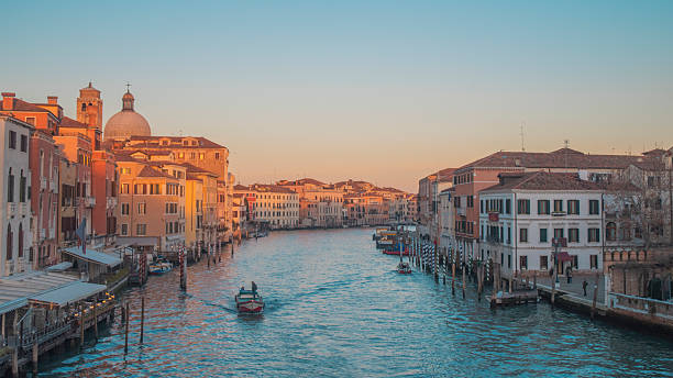 istock Boat in a canal in Venice at sunset 2219660869