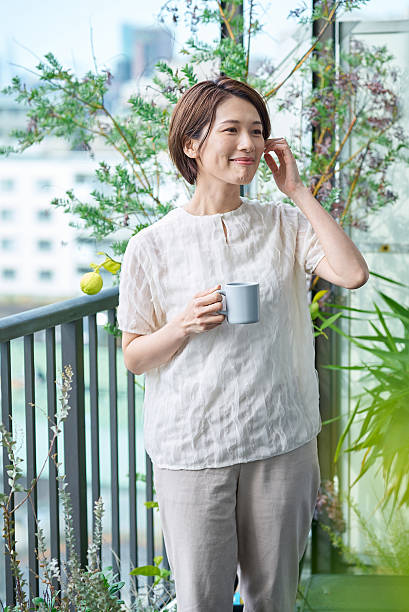 A woman with a relaxed expression holding a mug