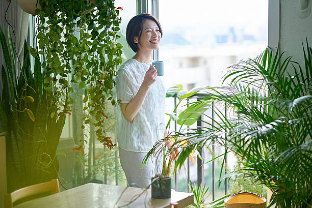 istock A woman relaxing surrounded by houseplants 2219665356