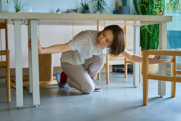 istock A woman hiding under a desk 2219665547
