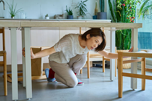 istock A woman hiding under a desk 2219665561
