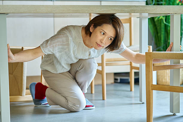 istock A woman hiding under a desk 2219665583