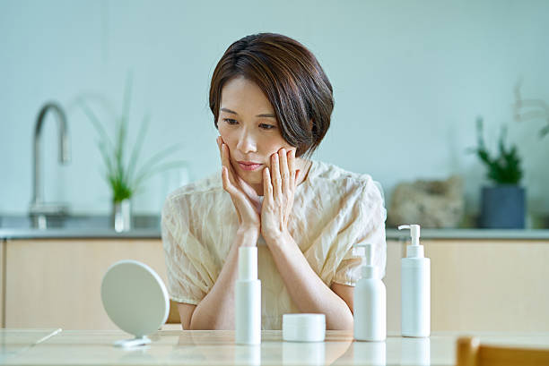 istock A woman with a tired look checking her face 2219666548