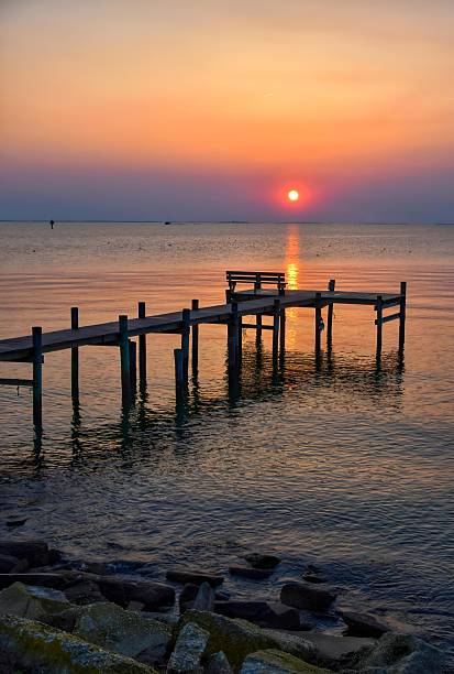 istock Spring sunrise in a smoky sky over a Chesapeake Bay pier 2219666555