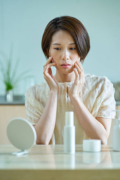 istock A woman with a tired look checking her face 2219666560