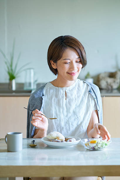 A woman eating breakfast in the room