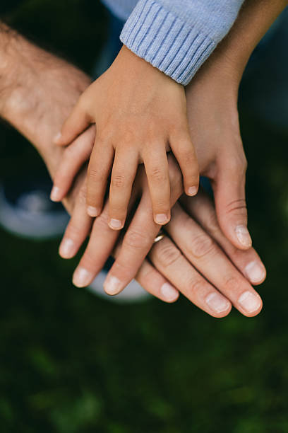 istock Family Hands Together Close-Up Unity Symbol 2219667612