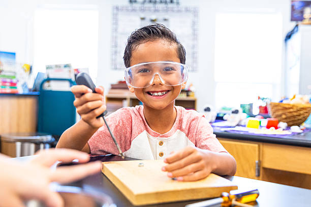 istock Portrait of a Cute Schoolboy engineering in the STEM science lab with his teacher 2219667708