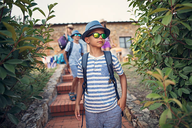 istock Group of travelers ascending brick stairs surrounded by lush greenery in a rustic setting 2219670096