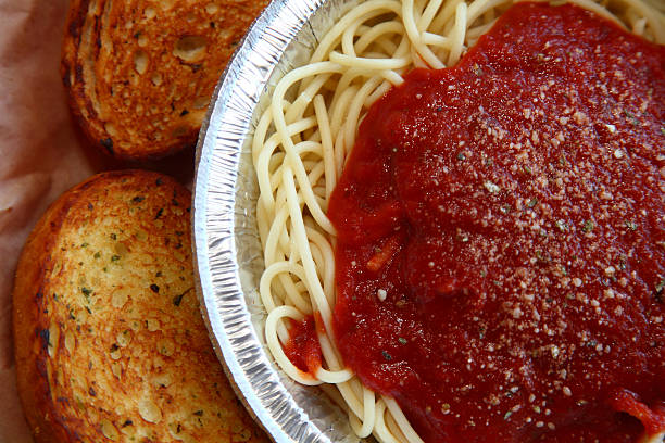 Spaghetti and meatballs with fettuccine and garlic bread.