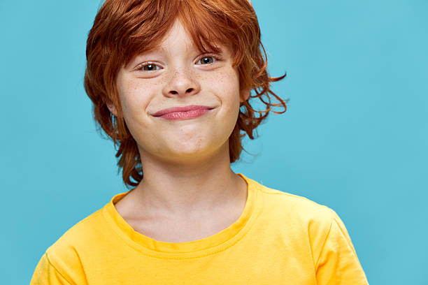 istock Sly boy with red hair planning something bad 2219670700
