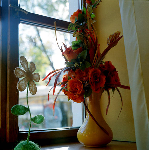 There is a vase with flowers on the table. Copy space.