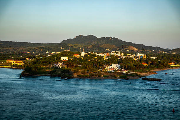 Puerto Plata, Dominican Republic, early morning, photographed from an arriving cruise ship, Atlantic Ocean in the foreground, mountains in the background.