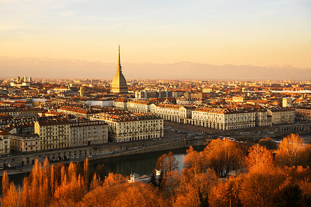 Evening view on the Turin city (Torino) during sunset. Mole Antonellia, Po river and Alps mountains on background. Piedmont, Italy