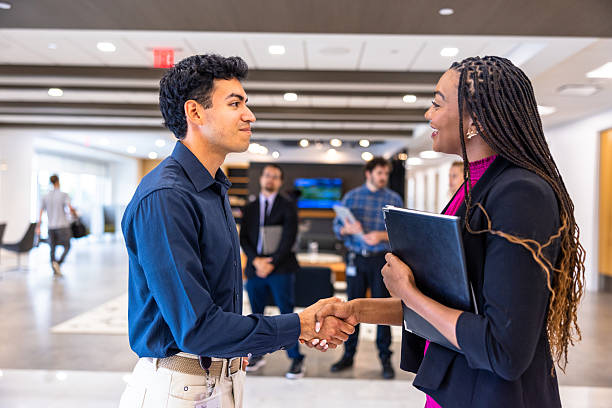 istock Business colleagues shaking hands in a hallway 2219677109