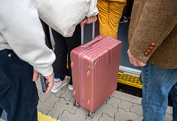 istock People boarding train with pink suitcase on station platform during travel 2219677362