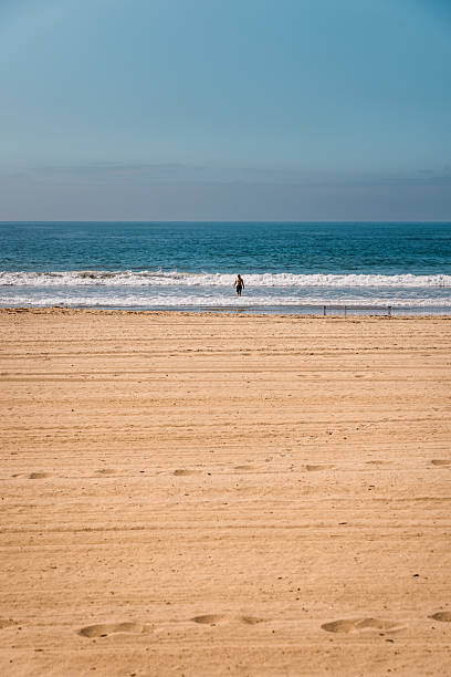 istock Solitary Man in the Pacific Ocean on a Sunny Day 2219677656