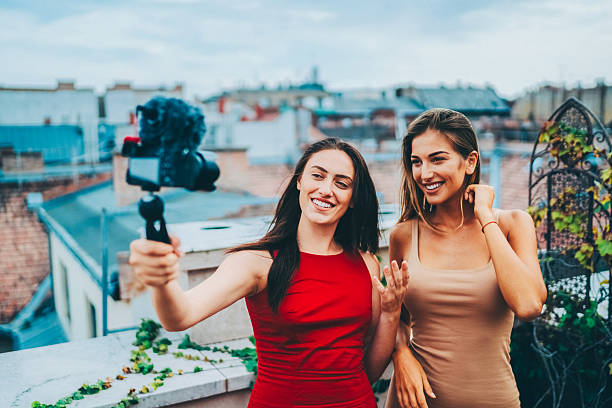 istock Influencer creating rooftop vlog content with friends. 2219678127