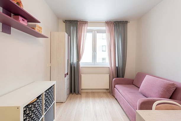 istock Cozy Minimalist Room with Pink Sofa and Natural Light 2219684043