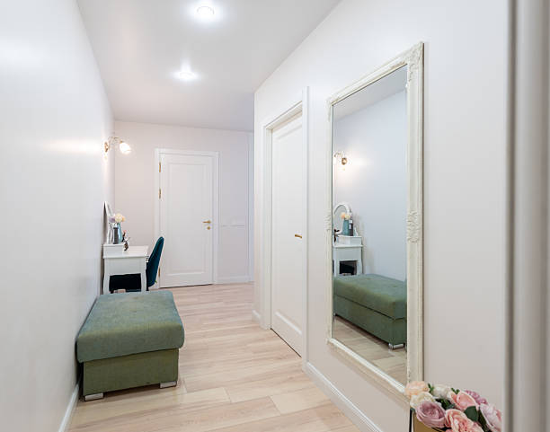 istock Modern Interior Setting With Mirror, Furnishings, and Decorative Flowers 2219684097