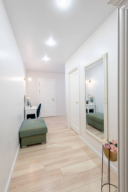 istock Modern Interior Setting With Mirror, Furnishings, and Decorative Flowers 2219684105