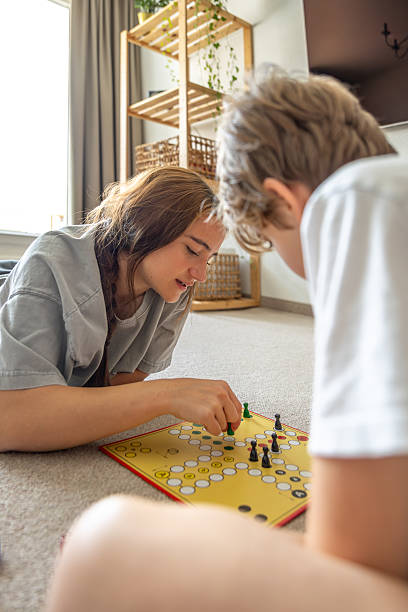 istock Girl playing board game with younger brother. Board game. Educational board game. 2219688728