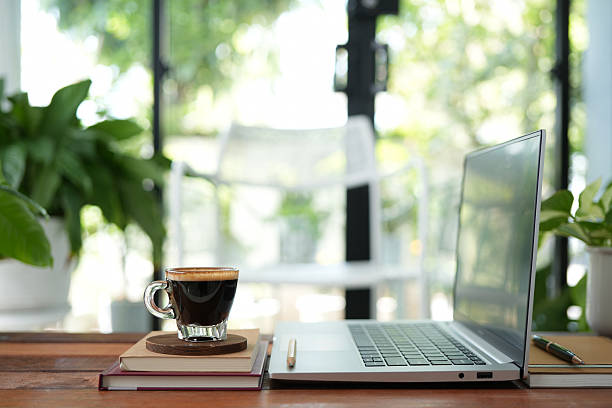 Coffee break and laptop on rustic wood table