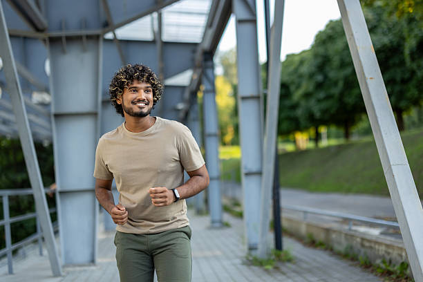istock Young man running and doing active physical exercises, dressed in sporty casual clothes 2219691354