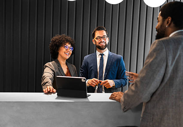 istock Businessman checking in at modern hotel reception desk 2219693246