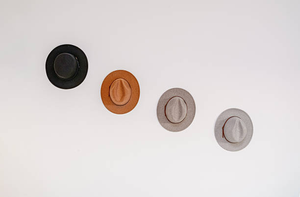 istock Cowboy western felt hats black brown gray. White wall with copy space 2219693953