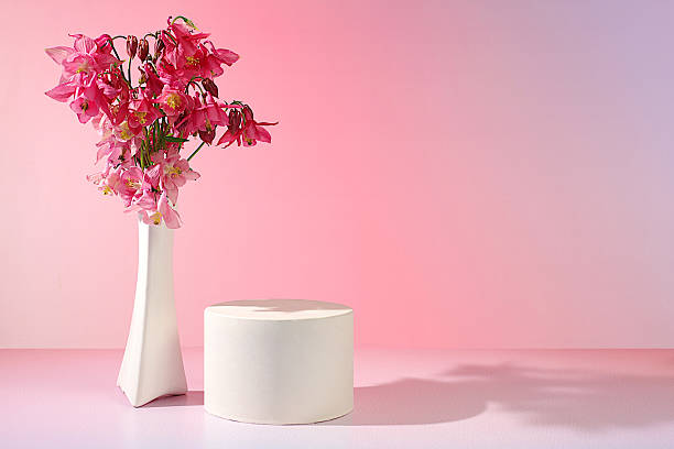 istock Abstract flower arrangement with empty podium for product display, template for display, Beautiful spring blooming columbine on sunny background, banner, still life with place for text, advertising flyer 2219697916