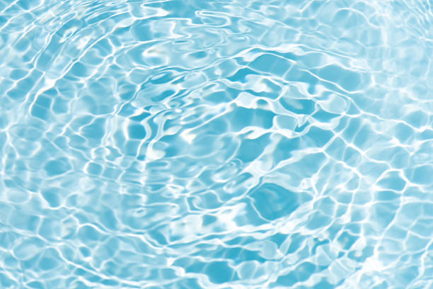 istock Blue water with ripples on the surface. Defocus blurred transparent blue colored clear calm water surface texture with splashes and bubbles. Water waves with shining pattern texture background. 2219702297