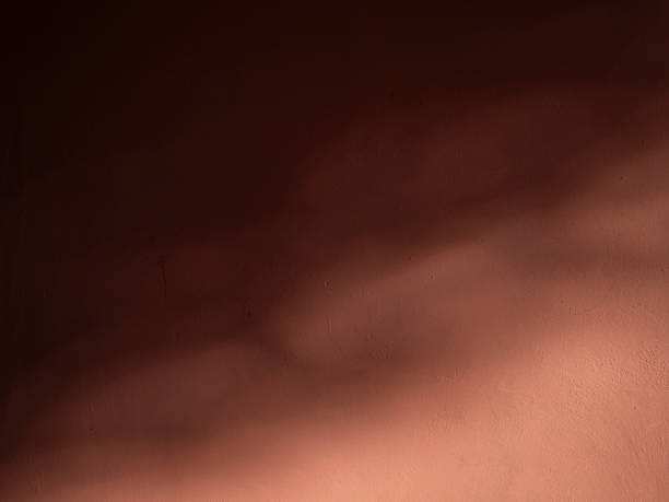 istock dark red background of wall in sunlight 2219706823