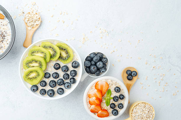 istock Oatmeal with strawberries and blueberries on white background 2219706875
