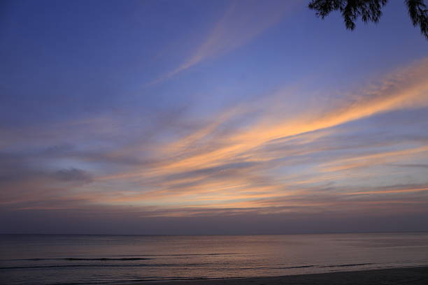 Sunset over the sea horizon. The sun is above the horizon. The surface of the sea with the reflection of sunlight on the waves. Adriatic Sea. Croatia.