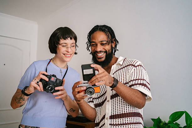 a company of friends uses a smartphone takes a selfie on the background of the city panorama.