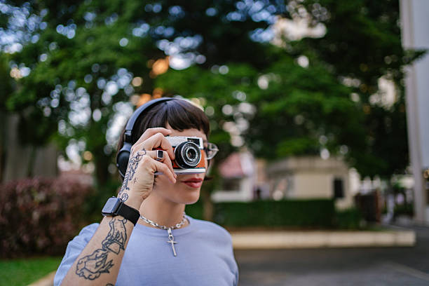 istock Young woman taking pictures with analog camera 2219713239