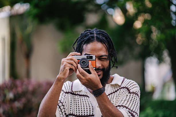 istock Young man taking pictures with analog camera 2219713254